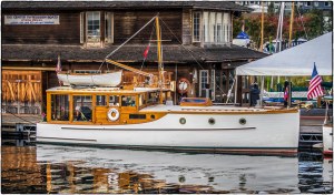 a wooden boat docked in front of the Center for Wooden Boats.