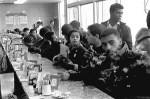 A group of African Americans sit at a counter in a diner to protest segregation laws