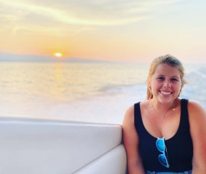 Elise sits aboard a small vessel on Flathead Lake in Montana.
