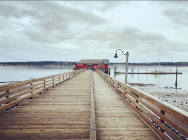 The Coupeville Wharf in Coupeville, WA stretches out via a short boardwalk, connecting to the town's waterfront during low tide.