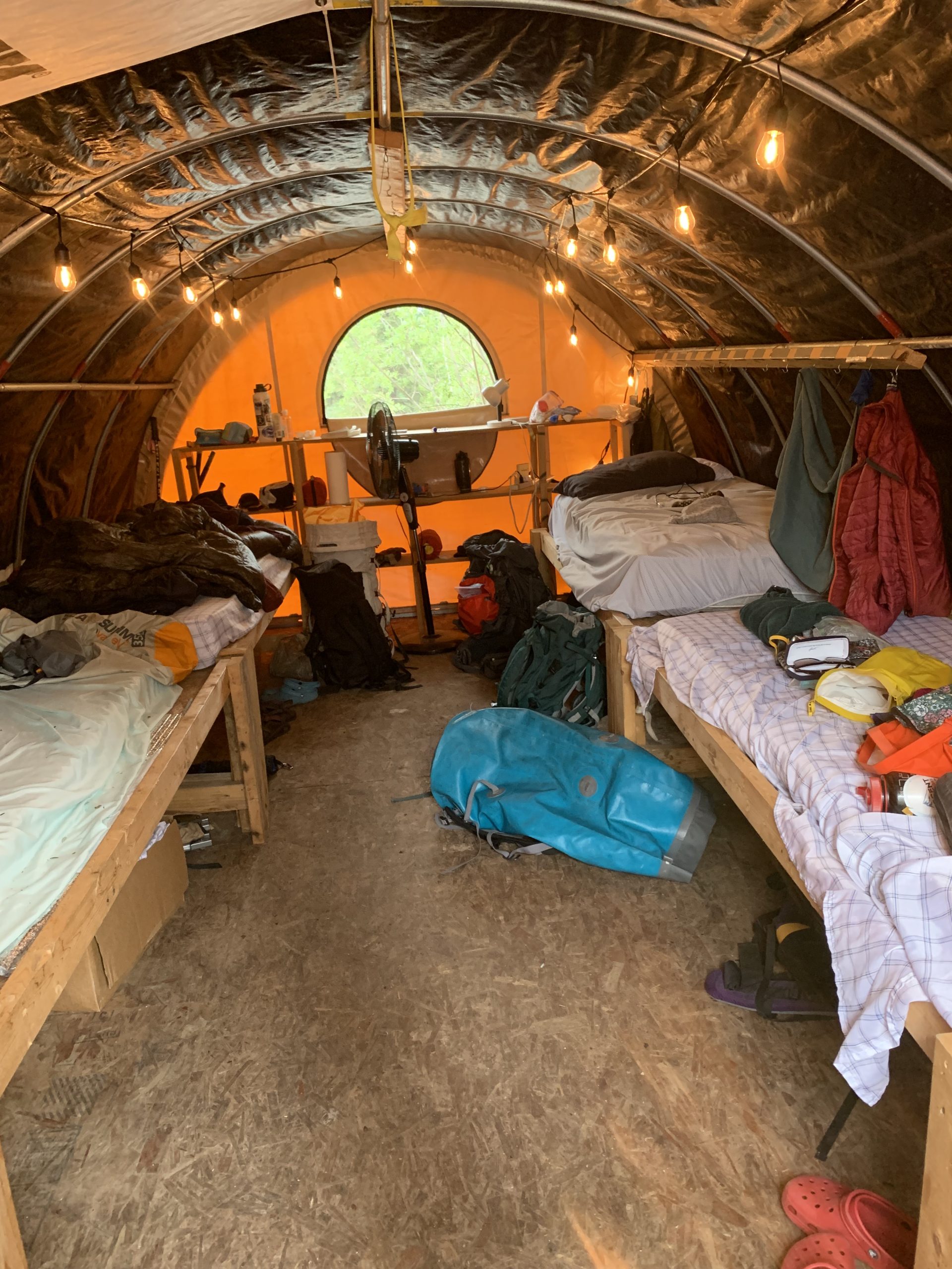 Gear and equipment is splayed out across four bunk beds in one of Guideland's 'glamping' canvas tents.