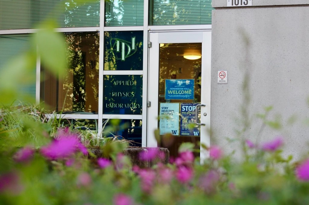 Alt text: Image depicts the door to Henderson Hall, which is adorned with the text "APL" and "Applied Physics Laboratory."