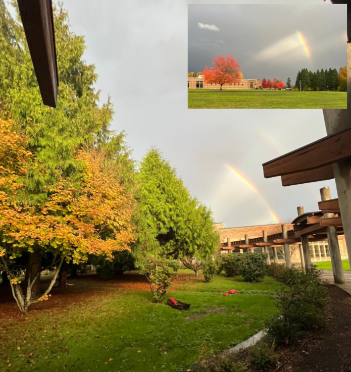 Alt text: A rainbow shines on a rainy day from the central courtyard at Chief Leschi Schools. In the upper-right corner, the rainbow is shining on the school from a distance.