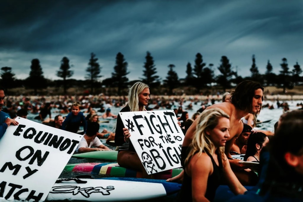 Alt text: Communities across Australia participating in the 2019 National Day of Action paddle outs to protest oil giant Equinor’s proposed drilling in the Great Australian Bight. This movement would come to represent the largest coastal environmental action in Australian history.