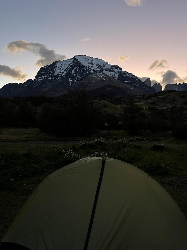Alt text: A lone, green tent sits below a mountain in Patagonia, Chile.